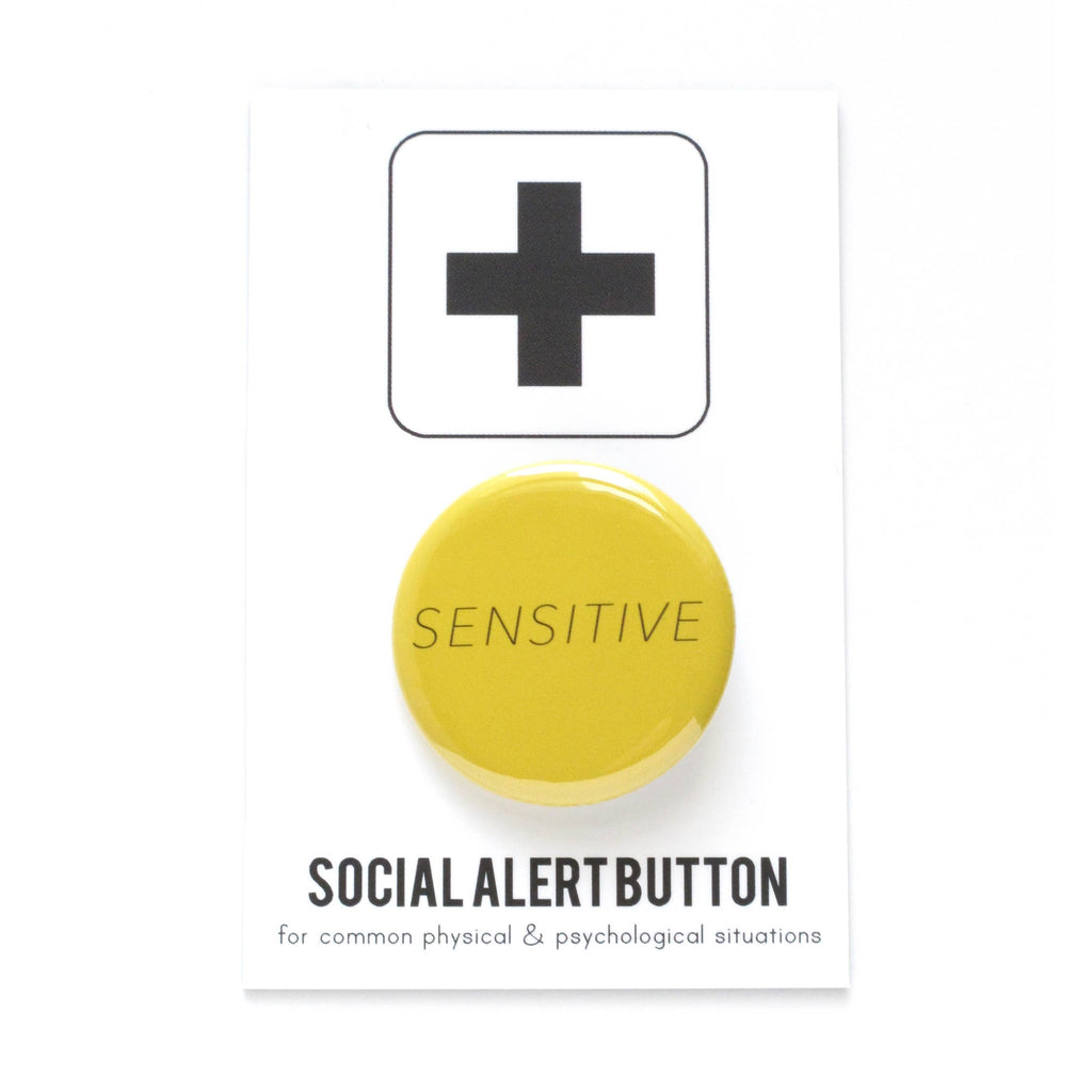 Yellow "Sensitive" Social Alert Pin Back Button at Golden Rule Gallery