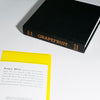 Black book titled 'Grapefruit' on a white surface with a yellow section of text.