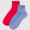 Red and blue socks with ruffled top on a light gray background