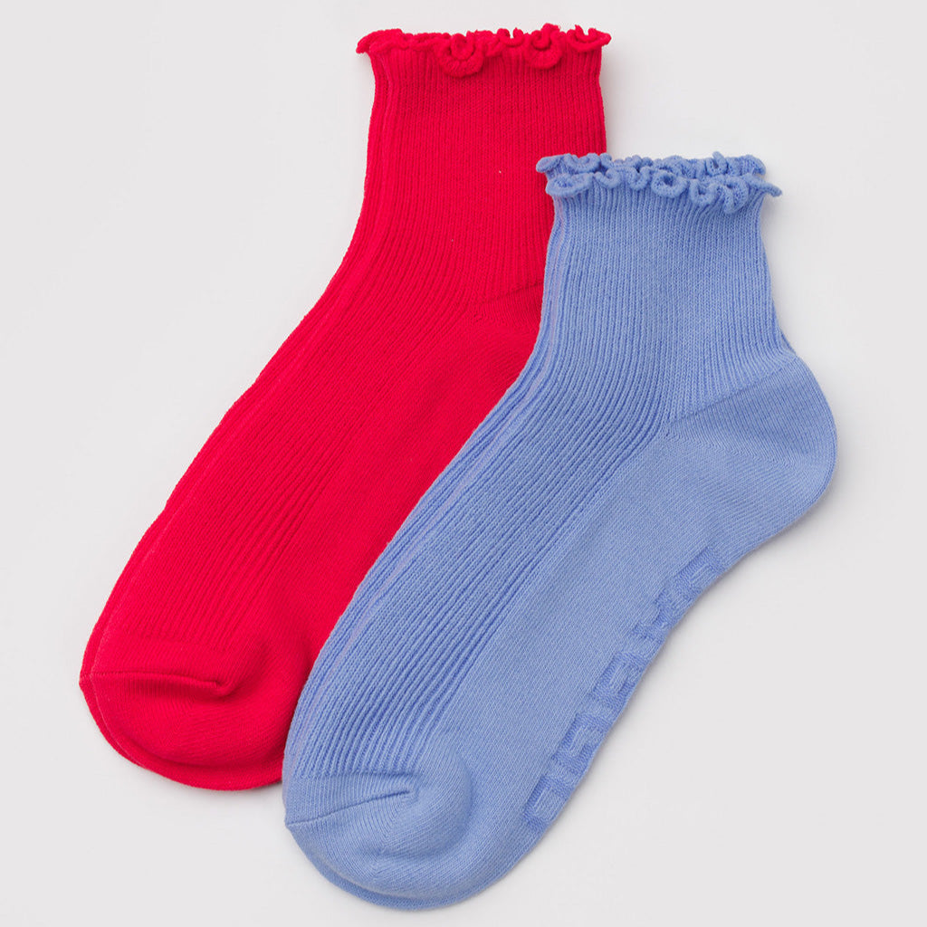 Red and blue socks with ruffled top on a light gray background
