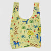 Reusable bag with colorful animal and nature pattern on a light yellow background