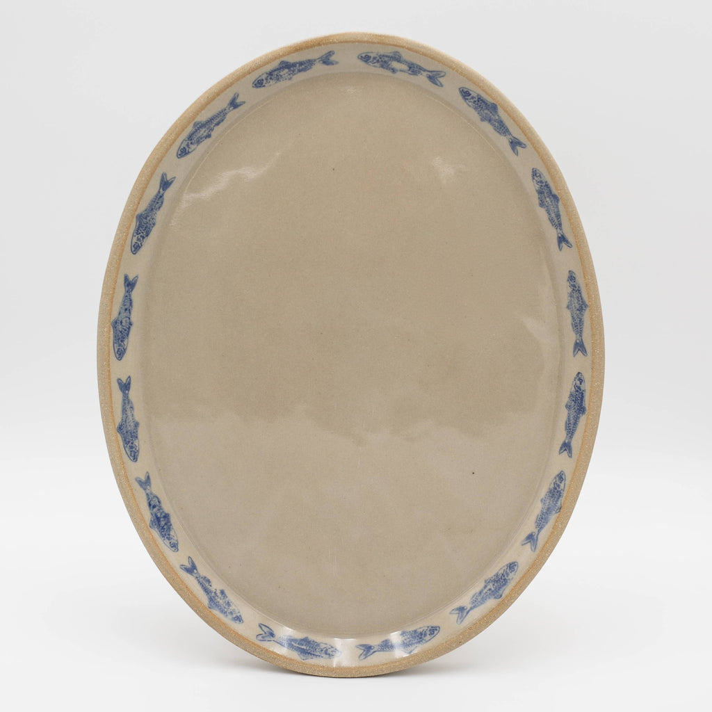 Ceramic bowl with blue sardine fish on a white background
