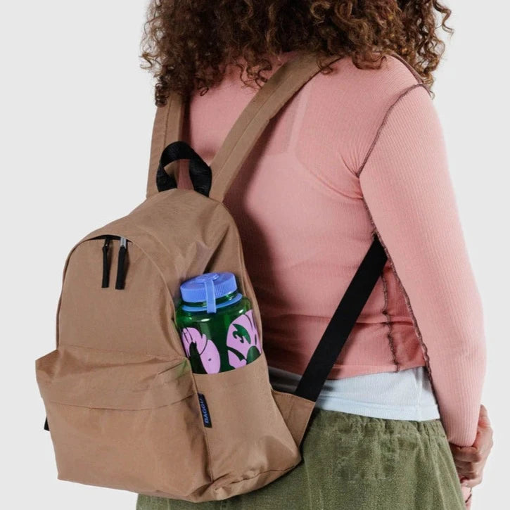 Model Wearing The Baggu Medium Nylon Backpack In Cocoa Brown