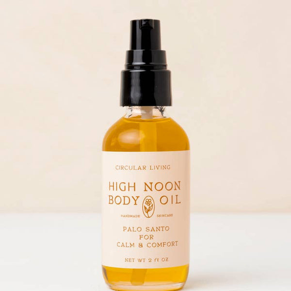 Bottle of High Noon Body Oil with a beige background