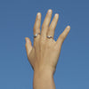 Hand with sterling silver organic shaped wave band ring
