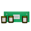 Three green candles in front of a green box with 'Flamingo Estate' branding on a white background.