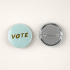 Dusty Blue Vote Pin Back Button by August Ink at Golden Rule Gallery in Excelsior, MN 