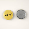 Yellow and Black Vote Pin Back Button by August Ink at Golden Rule Gallery in Excelsior, MN