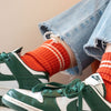 Close Up of Striped Thick Tube Socks in Coral Orange by Le Bon Shoppe