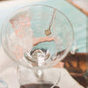 Close Up of Etched Bar Coupe Glass with Silver Dainty Heart Necklace 