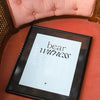 Framed print with 'bear witness' text on a red cushioned chair