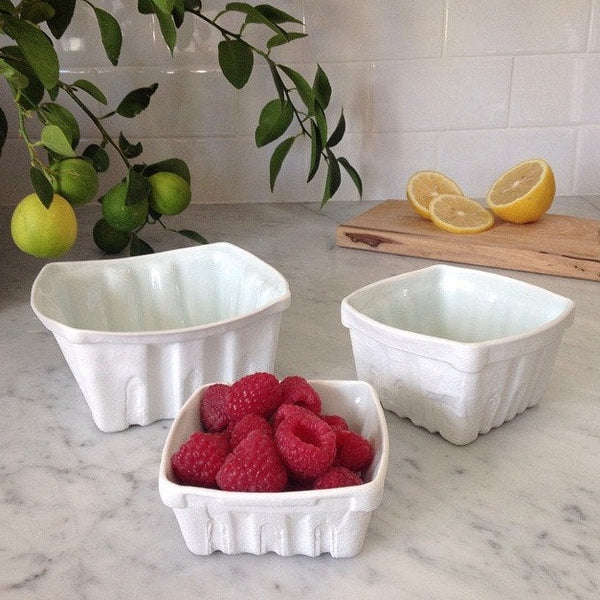 Ceramic white berry basket on a marble kitchen counter