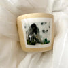 A MANO Hand Painted Ceramic Cup with Painted Mountain on White Fabric