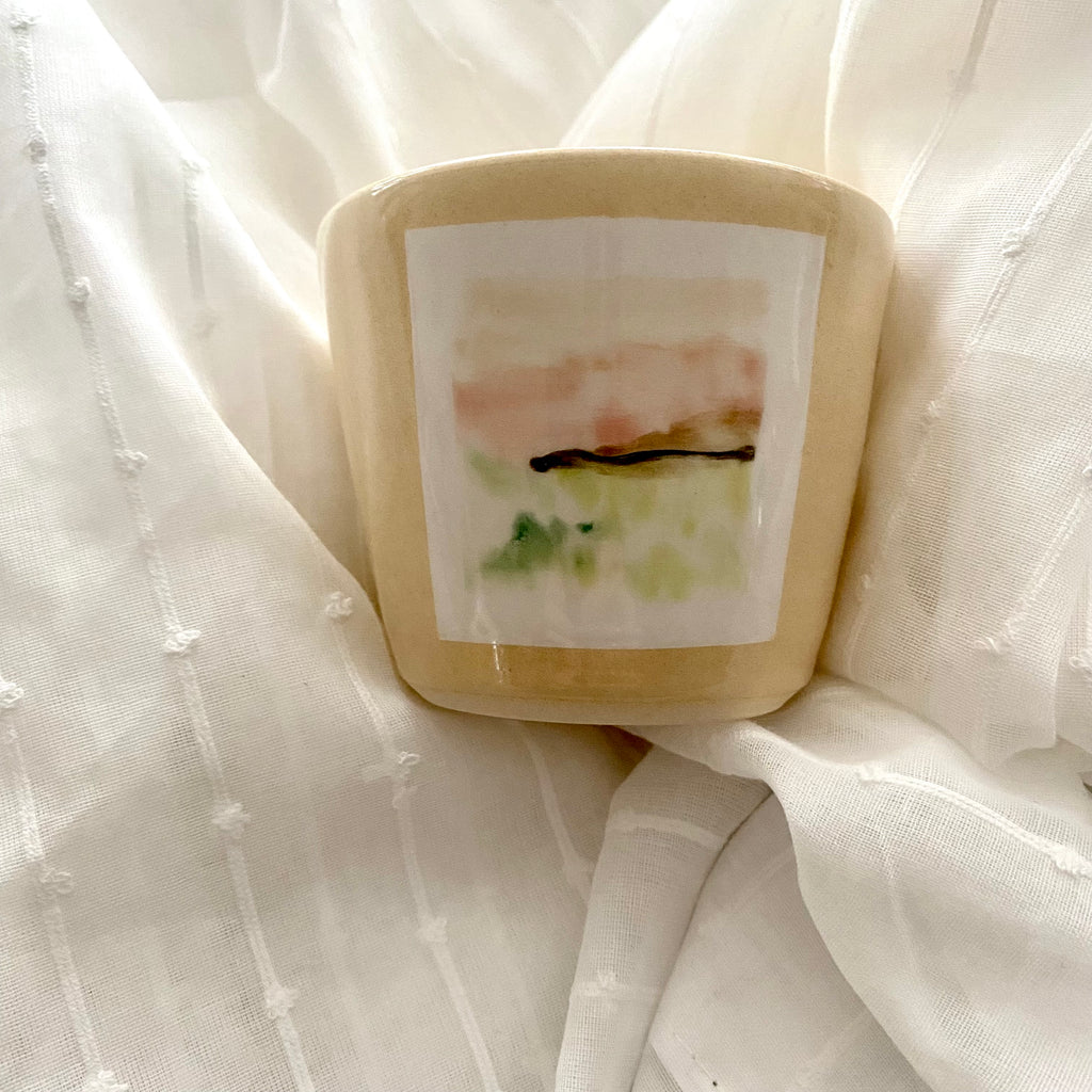 Cream Ceramic Cup by A MANO in Minneapolis with a Hand Painted Green Landscape Scene 