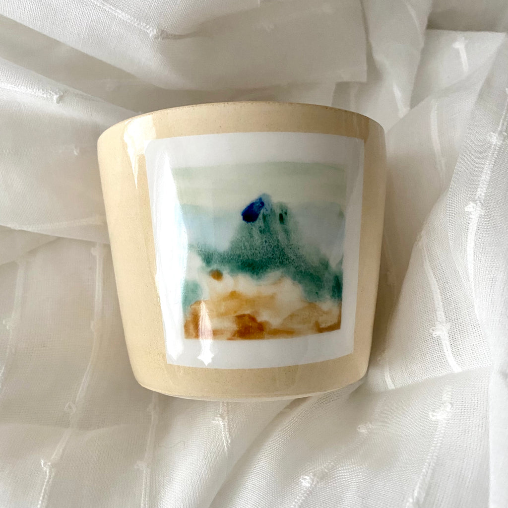 Hand Painted MPLS Landscape A MANO Ceramic Cup on White Fabric