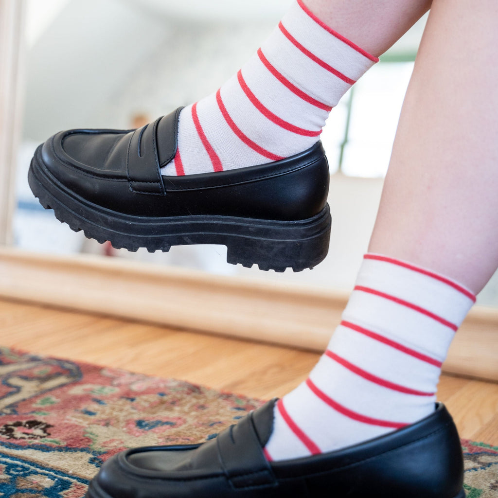 Model Styling Striped Red Socks with Black Loafers at Golden Rule Gallery