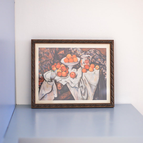 Professionally framed vintage Cézanne still life with apples and oranges on a blue counter