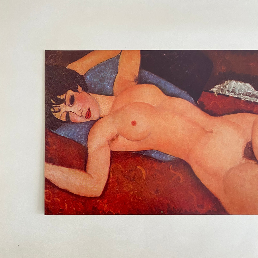 Vintage 50s first edition offset lithograph of a nude woman laying on a red cushion