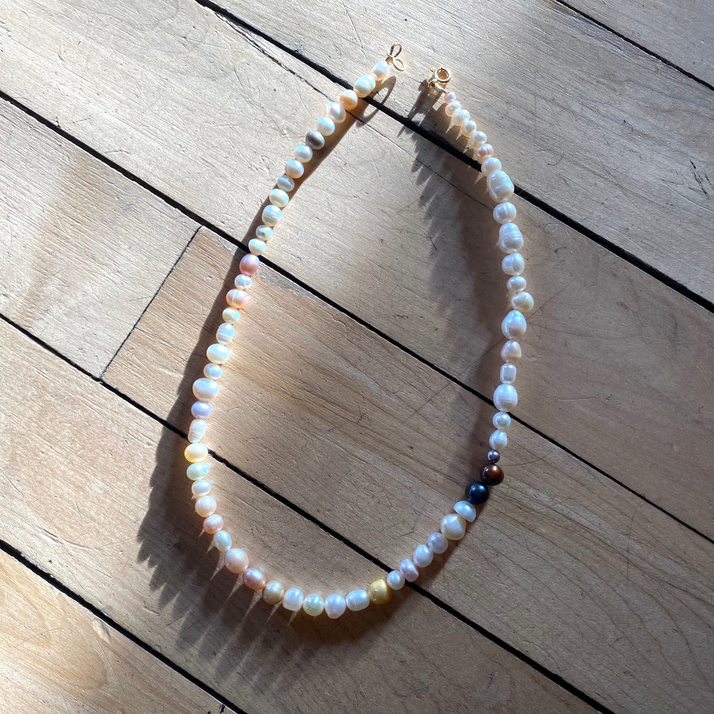 Multi-colored freshwater pearl necklace with gold clasp.
