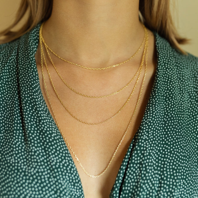 Pretty gold necklaces layered on model