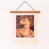 Vintage Renoir art print of a woman cleaning herself after a bath and this print is hanging on a poster hanger 