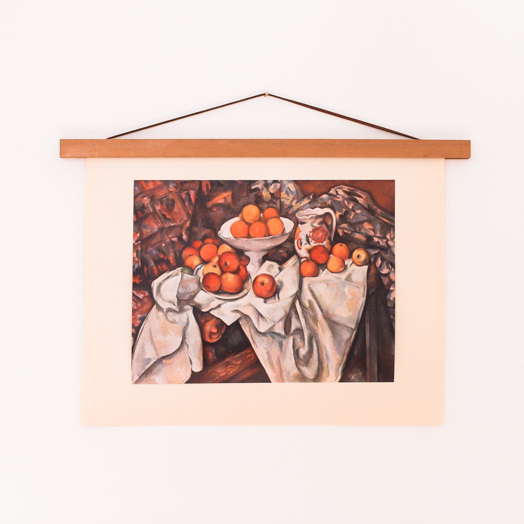 Vintage Cézanne still life with apples and oranges styled on a wood wall poster hanger 