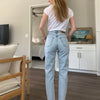 Model showing back of JUST Female light wash Stormy denim jeans from Golden Rule Gallery in Excelsior, MN