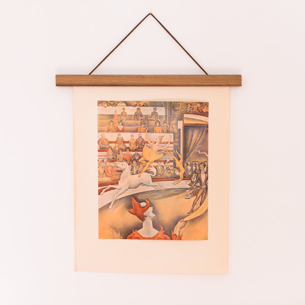 Vintage 50s Seurat Offset Lithograph of The Circus, hanging on a teakwood poster wall hanger