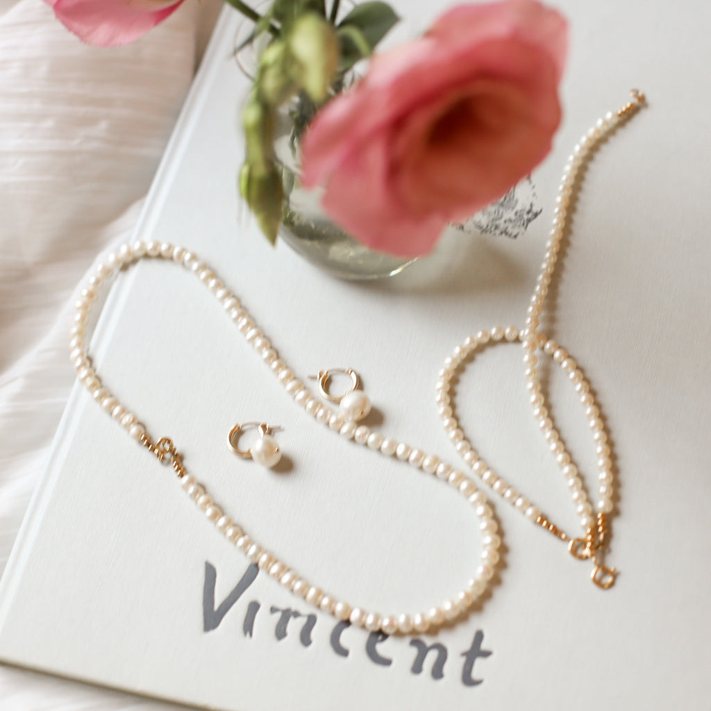 Timeless White Pearl Jewelry with Florals in a Vase